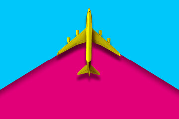 top view of a plane on a two color backgroind creative travel concept and copy space