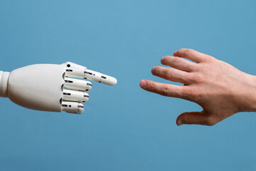 robotic arm touching human hand, man and machine friendship