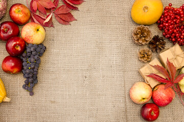 Autumn harvest of fruits and vegetables on a brown fabric background.Beautiful background with...
