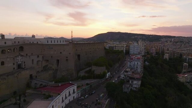 Fly Around Historic Castle Up On Hill Above City. Castel SantElmo Fortification At Twilight. Naples, Italy