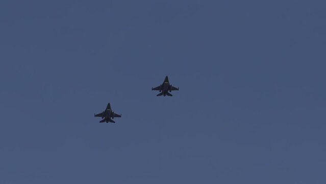 4K video with F16 hypersonic airplanes part of the Romanian Army Air Force in flight against blue sky background. Romania, 2022.