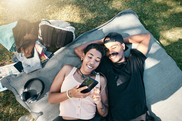 Phone, love and picnic with a couple lying on a field of grass outdoor while enjoying the freedom...