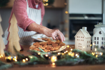 Close-up of senior man baking Christmas gingerbreads.