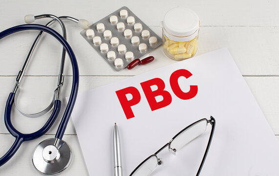 PBC word on paper with stethoscope and pills