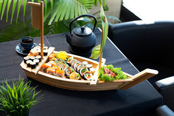 Colorful sushi on a wooden boat for serving sushi