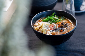 Oriental soup with dumplings and wakame algae