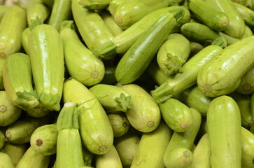 Fresh green zucchini on the counter in the store. Close-up of a showcase Young zucchini. A stall at a farmers' market.
