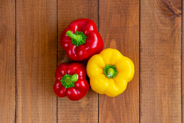 Ripe bell pepper on a wooden table. Vegetables on the table. Suitable for vegetarians. Diet food.
