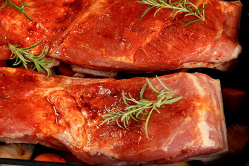 Marinated Fresh Pork belly with red pepper rosemary, spices and vegetables in a metal pan