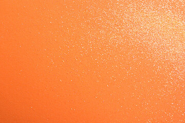 Shiny bright glitter on orange background, flat lay. Space for text