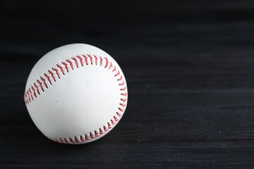 Baseball ball on black background, closeup with space for text. Sports game