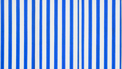 Close-up view on the abstract painted striped wall. Blue and white stripes on the wall.