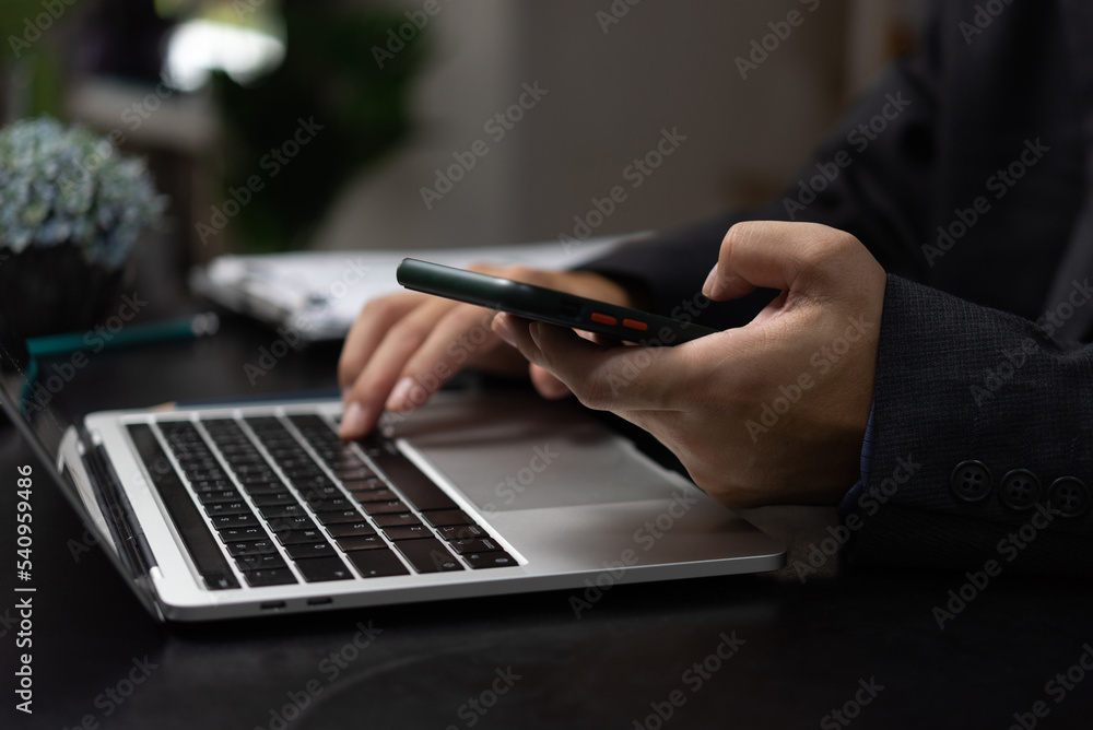 Aufkleber man with mobile smartphone in his hands and using keyboard laptop. modern digital technology concept