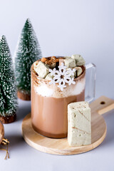 Glass Cup of Hot Cocoa served With Homemade Marshmallow Christmas Food Concept Christmas Decoration Blue Background Vertical
