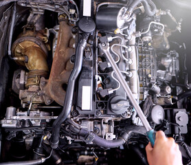 Car engine in garage, mechanic hands working on auto repair service and inspection of valve with...