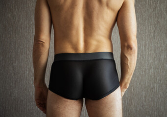Back and buttocks of young sporty man - obrazy, fototapety, plakaty