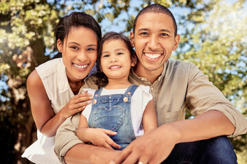 Portrait, child and parents with a smile in a park for relax, calm and peace together during summer. Happy, young and girl with her mother and father for adventure in nature garden or the countryside