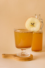 Hard Apple Cider Cocktail in Glass Decorated With Apple Slocee Autumn or Winter Drink Yellow Background Vertical
