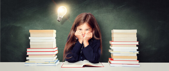 Young cute girl at chalkboard with light bulb over head