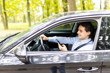 Man driving car and texting on the cellphone while drive