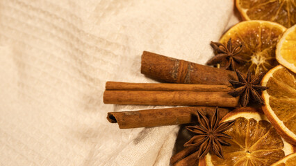 christmas winter food advent background - christmas scent, frame made of dried orange slices, cinnamon sticks and star anise, on table, top view