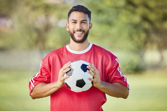 Sports man, soccer player and soccer field training with a soccer ball, happy and relax before fitness workout. Football, football player and sport portrait of excited player ready for game
