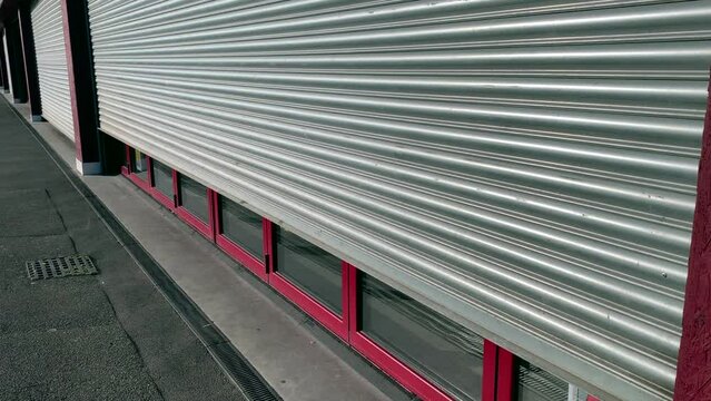 Clothing metal roller shutter doors on a retail unit on a high street