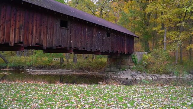 Wooden covered bridge over Bush Creek in Pennsylvania on a fall day