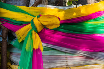 Colorful fabric wrapped around the tree, cloth wrapped around holy tree, Thailand's faith