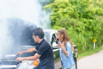 Road victims are shocked after an accident with smoking a car engine. on the road by a broken car...