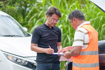 Fototapeta na wymiar Car insurance agent talks to his client about claiming a car repair service.