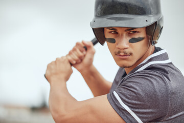 Focus, baseball and athlete with a bat on a field ready for the game or training with motivation. Mindset, fitness and man playing a softball match, sports exercise or workout on an outdoor pitch.