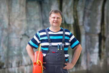 Fototapeta premium Portrait of adult man with lifebuoy near the water.