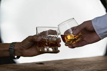 
Close-up of serious businessman holding whiskey glass shows concept of executive privilege. Soft...