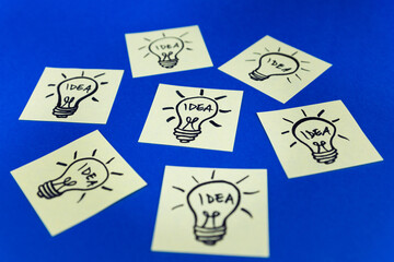 Light bulbs drawn on sticky notes. Hand drawn doodle lineart. Idea, inspiration and creative thinking
