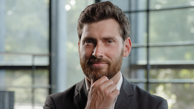 Portrait thoughtful Caucasian bearded 40s businessman thinking solving business problem pensive male think in office. Focused CEO boss leader clever puzzled confused man deep in planning thought