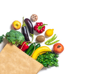 Eco friendly paper shop bag with raw organic green vegetables isolated on white background Flat lay, top view Zero waste, plastic free concept Healthy clean eating diet and detox, agriculture concept