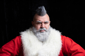 Evil aggressive gray-haired old man Santa in a bad mood. Severe dangerous Santa Claus with mohawk. New Year and Christmas in the company of an unusual bad Santa