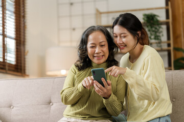 Mature asian mom with daughter on video call to parents, loving mother day concept.
