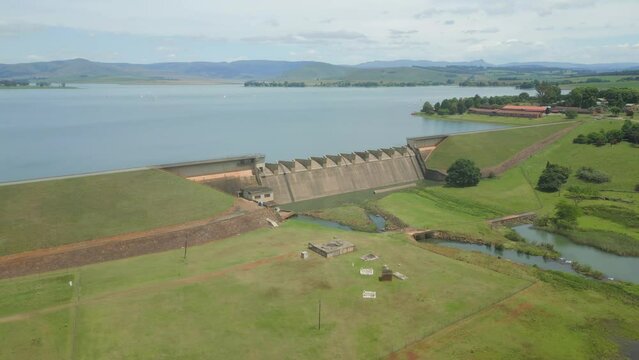 Aerial orbit of Midmar Dam wall, with mile long body of water behind