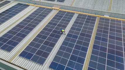 Engineer service and workers installation solar cell on the roof of factory industry. technician...