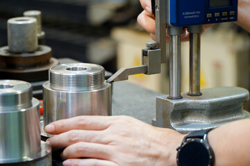 man measure part accuracy by height gauge, Tool for Inspection product in engineering lab, Digital system