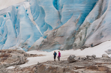 A man and a woman hiking at the Fabergstolsbreen glacier, the arm of  the Jostedalsbreen glacier,...