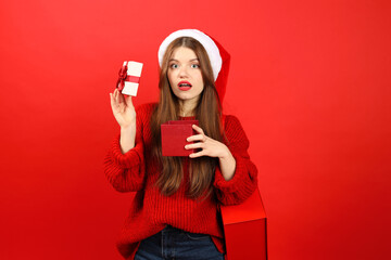 Young woman in New Year's clothes is upset with a Christmas gift, negative emotions. People on a...