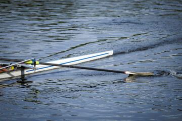 Oar paddle splashing water. Single scull man rower rowing on river