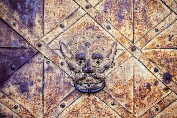Close up of an old metal medieval door knocker.