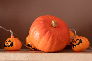 Electric halloween lights and an orange colour pumpkin decor on a fireplace background 