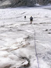 Foto op Canvas Hikers traveling on the white glacier in the Alps © Birdie Bird/Wirestock Creators