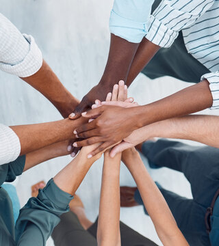 Diversity, hands and team above in support, trust and unity for collaboration, agreement or meeting at the office. Group hand of diverse people in teamwork, cooperation and solidarity for community