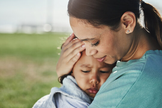 Comfort, Mother And Sad Baby With Anxiety, Fear And Frustrated With Problems Being Supported And Loved By Mom. Family, Grief And Mama Carrying A Moody And Angry Girl Child Or Kid At A Park Outdoors